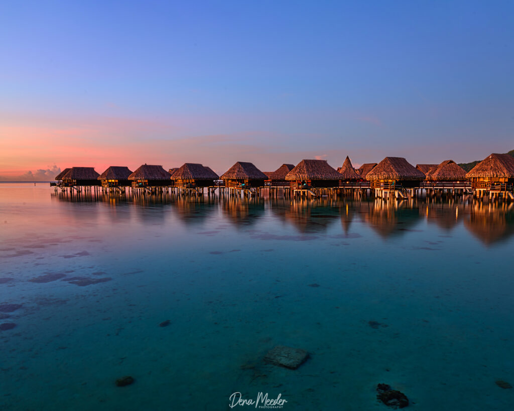 The Sofitel Kia Ora Moorea Beach Resort from the edge of the water looking at over a dozen over water bungalows.