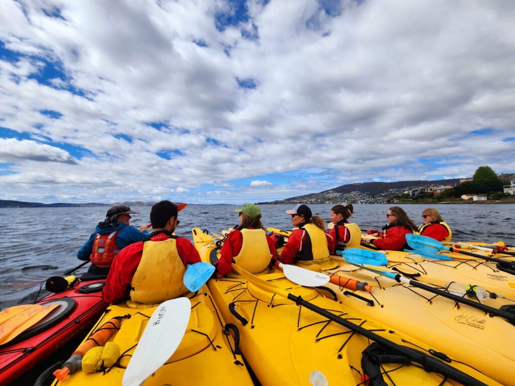 Roseann Iovine (Founder of Outdoor Travel Adventures) and tour group kayaking in the Hobart harbor.